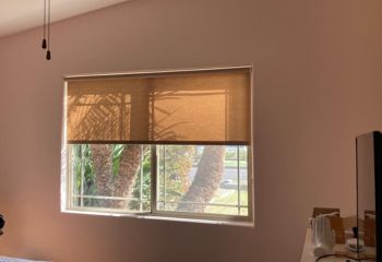 Close-up of custom pull down window shades neatly installed inside a San Diego bedroom window.