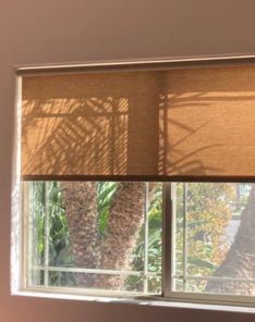 Close-up of custom pull down window shades neatly installed inside a San Diego bedroom window.