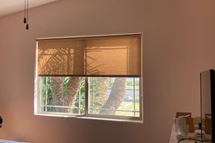 Close-up of custom pull down window shades neatly installed inside a San Diego bedroom window.