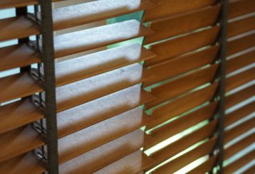 Elegant wooden blinds complementing a San Diego bedroom