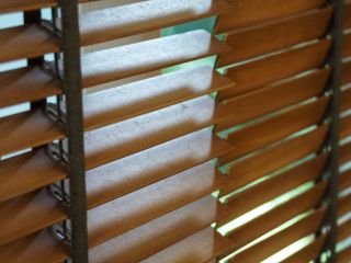 Elegant wooden blinds complementing a San Diego bedroom